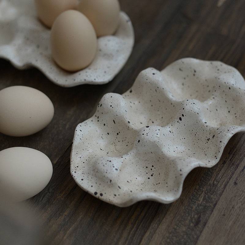 Nordic style resin egg storage box with 6 cells on wooden surface.