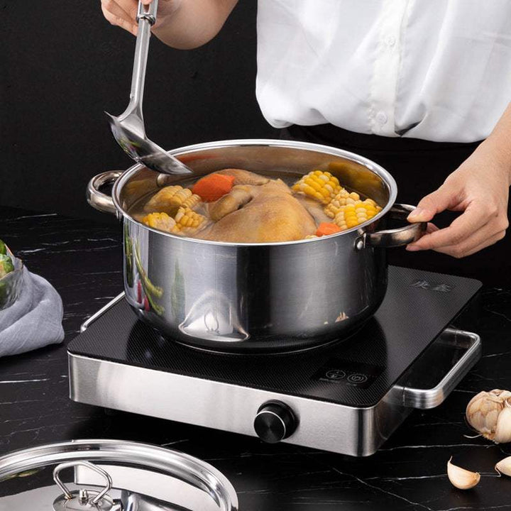 15-piece stainless steel cookware set with glass lids and non-stick features, shown with food on an induction stove.