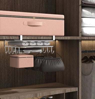 Under shelf storage cutting board organizer in a modern cabinet setup, featuring hooks and compartments for efficient space utilization.