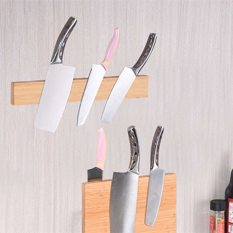 Bamboo wall-mounted magnet knife holder displaying various knives.