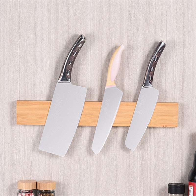 Bamboo wall-mounted magnet knife holder with three knives.