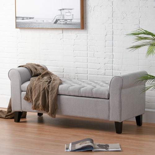 Light grey HAYES ARMED STORAGE BENCH with rolled arms and button-tufted design in a contemporary setting.
