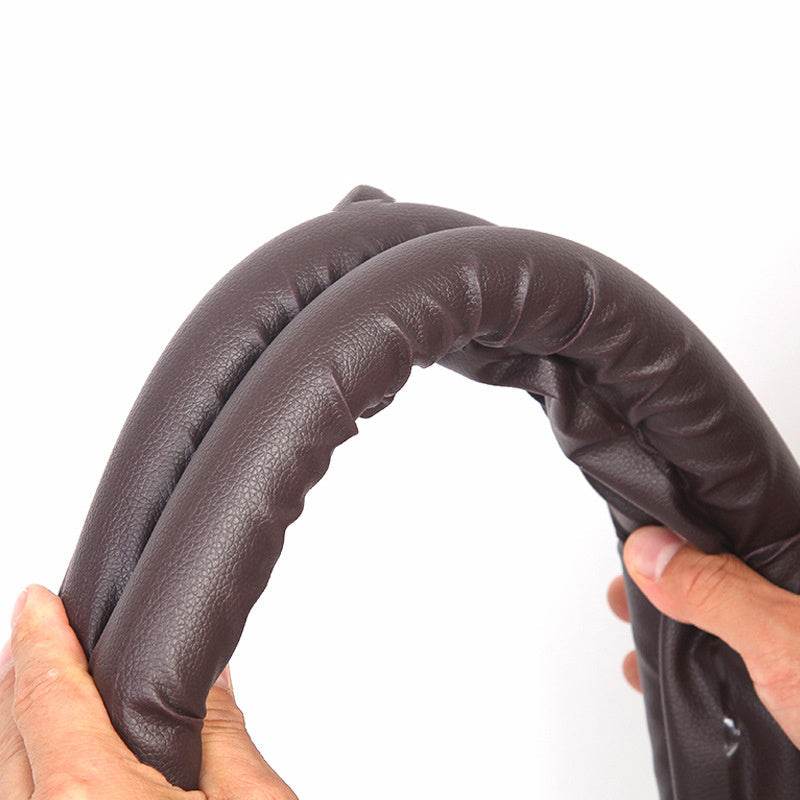 Close-up of a flexible brown door bottom sealing strip being held, demonstrating its use for sealing door gaps.  