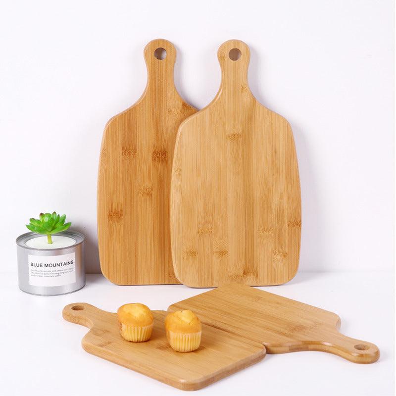 Modern minimalist wooden cutting boards with hanging handles.