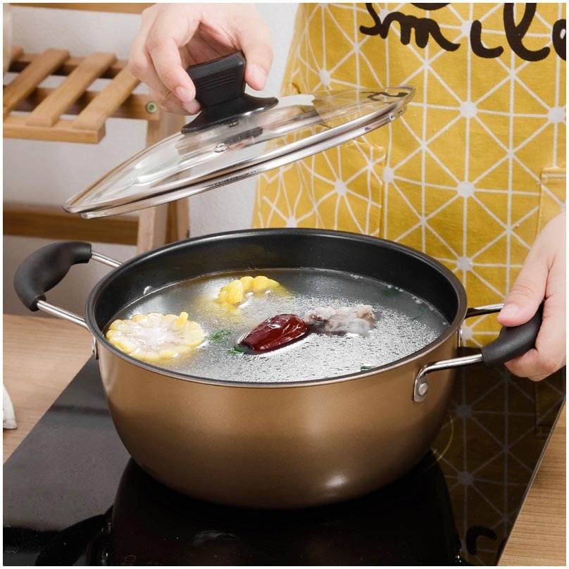 Cast iron non-stick soup pot with ingredients, part of light luxury three-piece cookware set.