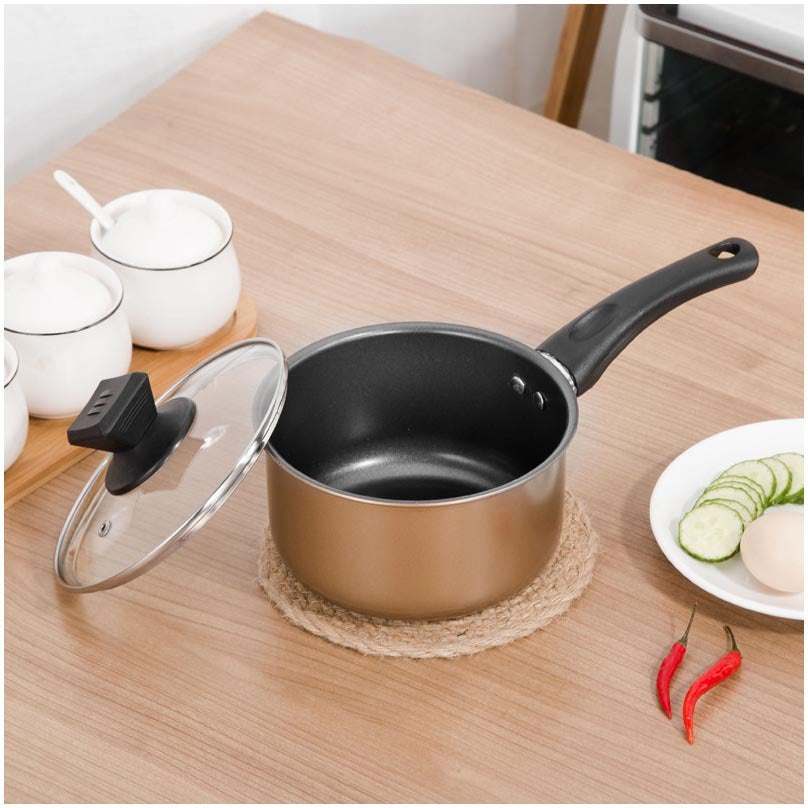 Cast iron non-stick pot on kitchen countertop with lid, part of a three-piece cookware set.