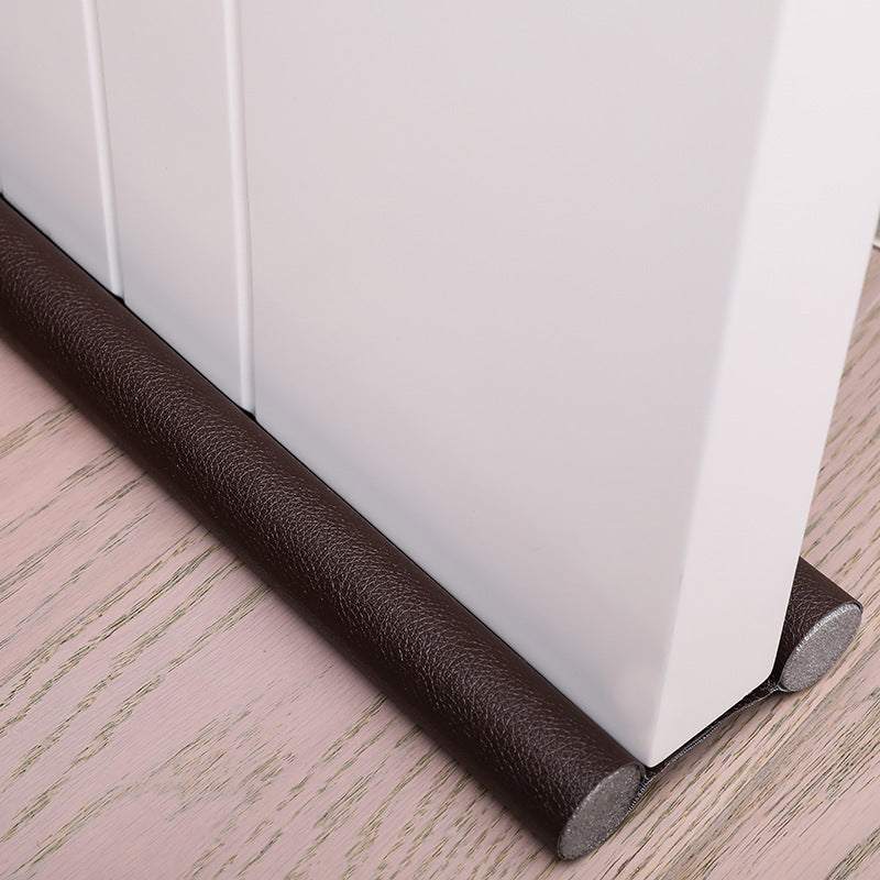 Door bottom sealing strip in brown for gap reduction and insulation. 