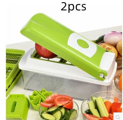 Multifunctional vegetable chopper with green handle slicing vegetables on countertop.  