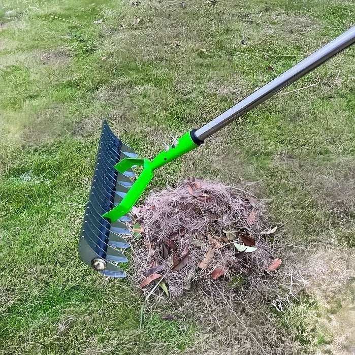 Gardening tools lawn hay rake on grass with withered debris.